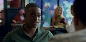 Movie still from “13 Reasons Why” (2017), created by Brian Yorkey – A man sitting in front of a woman in front of a window; Close Up shot, Over the shoulder angle