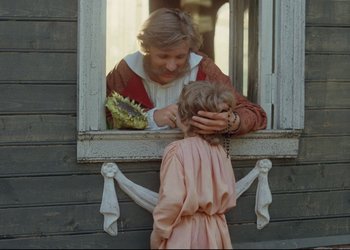 Movie still from “A Few Days from the Life of I.I. Oblomov” (1980), directed by Nikita Mikhalkov – An older woman and a young girl looking in a window; Medium shot, Over the shoulder angle