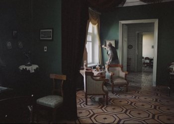 Movie still from “A Few Days from the Life of I.I. Oblomov” (1980), directed by Nikita Mikhalkov – A room filled with furniture and a large window; Wide shot, High angle