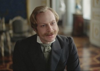 Movie still from “A Few Days from the Life of I.I. Oblomov” (1980), directed by Nikita Mikhalkov – A man in a suit and tie with a mustache; Close Up shot, Over the shoulder angle