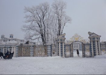 Movie still from “A Few Days from the Life of I.I. Oblomov” (1980), directed by Nikita Mikhalkov – A person walking in front of a gate in the snow; Extreme Wide shot, Low angle