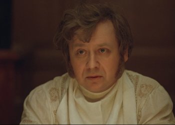 Movie still from “A Few Days from the Life of I.I. Oblomov” (1980), directed by Nikita Mikhalkov – A person wearing a white shirt; Close Up shot, Over the shoulder angle