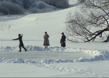 Movie still from “A Few Days from the Life of I.I. Oblomov” (1980), directed by Nikita Mikhalkov – A group of people standing on top of a snow covered slope; Extreme Wide shot, High angle