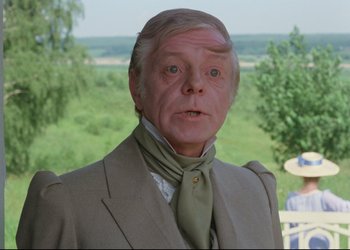 Movie still from “A Few Days from the Life of I.I. Oblomov” (1980), directed by Nikita Mikhalkov – An older man in a suit and a green neck tie; Close Up shot, Over the shoulder angle