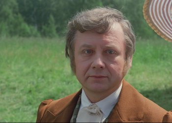 Movie still from “A Few Days from the Life of I.I. Oblomov” (1980), directed by Nikita Mikhalkov – An older man in a brown jacket and a white tie; Close Up shot, Over the shoulder angle