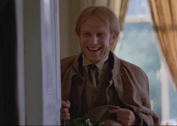 Movie still from “A Few Days from the Life of I.I. Oblomov” (1980), directed by Nikita Mikhalkov – A man with blonde hair is smiling for the camera; Close Up shot, Low angle