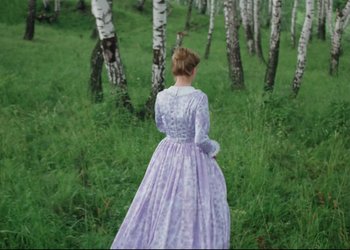 Movie still from “A Few Days from the Life of I.I. Oblomov” (1980), directed by Nikita Mikhalkov – A woman in a long purple dress standing in a field; Wide shot, High angle