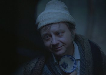 Movie still from “A Few Days from the Life of I.I. Oblomov” (1980), directed by Nikita Mikhalkov – A person wearing a white hat and a sweater; Close Up shot, Over the shoulder angle