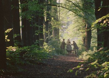 Movie still from “A Few Days from the Life of I.I. Oblomov” (1980), directed by Nikita Mikhalkov – A group of people sitting on a bench in the middle of a forest; Extreme Wide shot, High angle