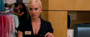 Movie still from “Observe and Report” (2009), directed by Jody Hill – A woman in a black shirt is standing in a room; Close Up shot, Over the shoulder angle
