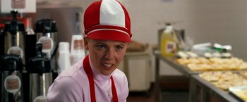Movie still from “Observe and Report” (2009), directed by Jody Hill – A woman wearing a red and white hat and apron; Close Up shot, Over the shoulder angle