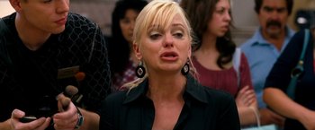 Movie still from “Observe and Report” (2009), directed by Jody Hill – A blonde woman with long hair wearing a black shirt; Close Up shot, Low angle