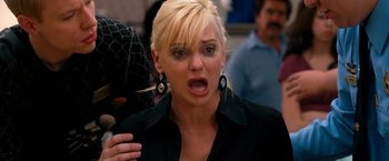 Movie still from “Observe and Report” (2009), directed by Jody Hill – A woman with a surprised look on her face; Close Up shot, Over the shoulder angle