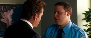 Movie still from “Observe and Report” (2009), directed by Jody Hill – A man in a business suit and a police officer; Close Up shot, Over the shoulder angle