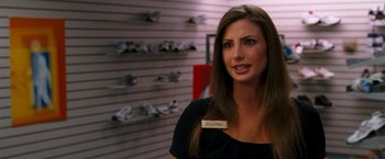 Movie still from “Observe and Report” (2009), directed by Jody Hill – A beautiful woman standing next to a wall of shoes; Close Up shot, Over the shoulder angle