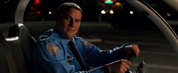 Movie still from “Observe and Report” (2009), directed by Jody Hill – A police officer sitting on a motorcycle at night; Close Up shot, Low angle