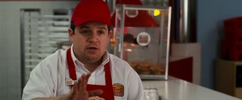 Movie still from “Observe and Report” (2009), directed by Jody Hill – A man wearing a red hat and a white apron; Close Up shot, Over the shoulder angle