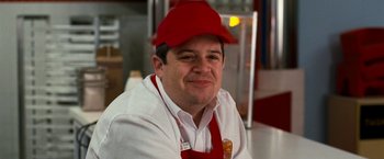 Movie still from “Observe and Report” (2009), directed by Jody Hill – A man wearing a red hat and apron; Close Up shot, Low angle