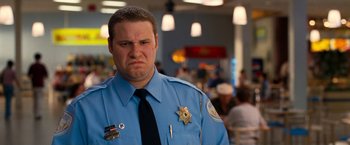 Movie still from “Observe and Report” (2009), directed by Jody Hill – A man in a police officer's blue uniform; Close Up shot, Low angle