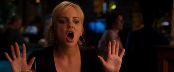 Movie still from “Observe and Report” (2009), directed by Jody Hill – A woman with her mouth wide open holding her hand up in the air; Close Up shot, Over the shoulder angle