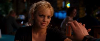 Movie still from “Observe and Report” (2009), directed by Jody Hill – A woman with blonde hair sitting at a table with a glass of beer in front of her; Close Up shot, Over the shoulder angle