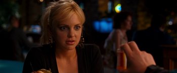Movie still from “Observe and Report” (2009), directed by Jody Hill – A blonde woman with blue eyes is sitting at a table; Close Up shot, Over the shoulder angle