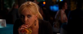 Movie still from “Observe and Report” (2009), directed by Jody Hill – A woman sitting at a table with a sandwich in her hand; Close Up shot, Over the shoulder angle