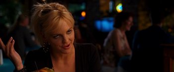 Movie still from “Observe and Report” (2009), directed by Jody Hill – A woman sitting at a table in front of a crowd of onlookers; Close Up shot, Over the shoulder angle