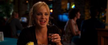 Movie still from “Observe and Report” (2009), directed by Jody Hill – A beautiful blonde woman holding a glass of wine; Close Up shot, Over the shoulder angle