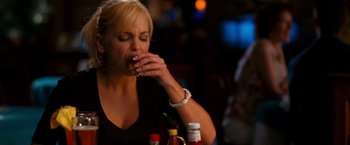 Movie still from “Observe and Report” (2009), directed by Jody Hill – A woman sitting at a table eating a hot dog; Close Up shot, Overhead angle