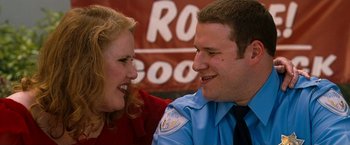 Movie still from “Observe and Report” (2009), directed by Jody Hill – A man and a woman smiling at each other; Close Up shot, Over the shoulder angle
