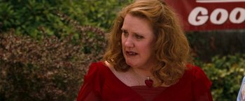 Movie still from “Observe and Report” (2009), directed by Jody Hill – A person wearing a red dress; Close Up shot, Over the shoulder angle