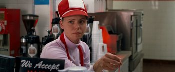 Movie still from “Observe and Report” (2009), directed by Jody Hill – A woman wearing a red and white hat sitting at a counter; Close Up shot, Over the shoulder angle
