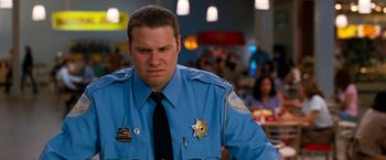 Movie still from “Observe and Report” (2009), directed by Jody Hill – A police officer in a blue uniform looking sad; Close Up shot, Low angle