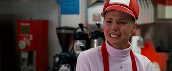 Movie still from “Observe and Report” (2009), directed by Jody Hill – A woman wearing a red and white hat is crying; Close Up shot, Over the shoulder angle
