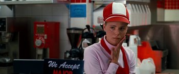 Movie still from “Observe and Report” (2009), directed by Jody Hill – A woman wearing a red and white hat in front of a coffee shop; Close Up shot, Over the shoulder angle