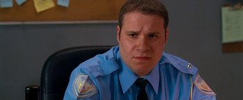 Movie still from “Observe and Report” (2009), directed by Jody Hill – A police officer sitting in a chair with his eyes wide open; Close Up shot, Low angle