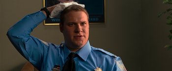 Movie still from “Observe and Report” (2009), directed by Jody Hill – A police officer with his head in his hands; Close Up shot, Low angle