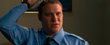 Movie still from “Observe and Report” (2009), directed by Jody Hill – A man in a blue shirt and a black tie; Close Up shot, Low angle