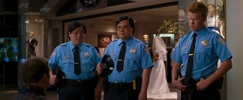 Movie still from “Observe and Report” (2009), directed by Jody Hill – A couple of men standing next to each other in a room; Medium shot, Low angle