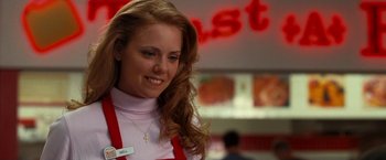 Movie still from “Observe and Report” (2009), directed by Jody Hill – A woman with long red hair standing in front of a sign; Close Up shot, Over the shoulder angle