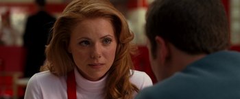 Movie still from “Observe and Report” (2009), directed by Jody Hill – A person sitting at a table with another person; Close Up shot, Over the shoulder angle