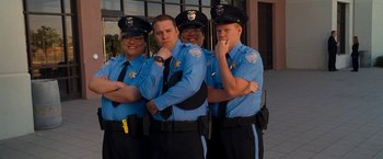 Movie still from “Observe and Report” (2009), directed by Jody Hill – A group of police officers standing next to each other; Medium shot, Low angle