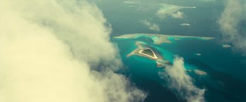 Movie still from “Oceans” (2009), directed by Jacques Cluzaud – An aerial view of an island in the middle of the ocean; Extreme Wide shot, Overhead angle