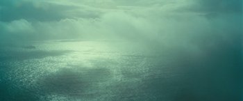 Movie still from “Oceans” (2009), directed by Jacques Cluzaud – A view of a body of water under a cloudy sky; Extreme Wide shot, High angle