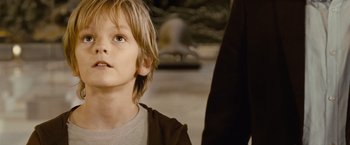 Movie still from “Oceans” (2009), directed by Jacques Cluzaud – A young boy is looking up at something in the distance; Close Up shot, Over the shoulder angle