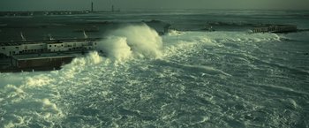 Movie still from “Oceans” (2009), directed by Jacques Cluzaud – Waves crashing on the shore of a body of water; Extreme Wide shot, High angle