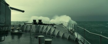 Movie still from “Oceans” (2009), directed by Jacques Cluzaud – Waves crashing on a boat in the ocean; Extreme Wide shot, High angle