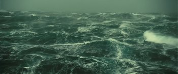 Movie still from “Oceans” (2009), directed by Jacques Cluzaud – A large body of water that is very green; Extreme Wide shot, High angle