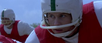 Movie still from “October Sky” (1999), directed by Joe Johnston – A person wearing a football helmet; Close Up shot, Low angle